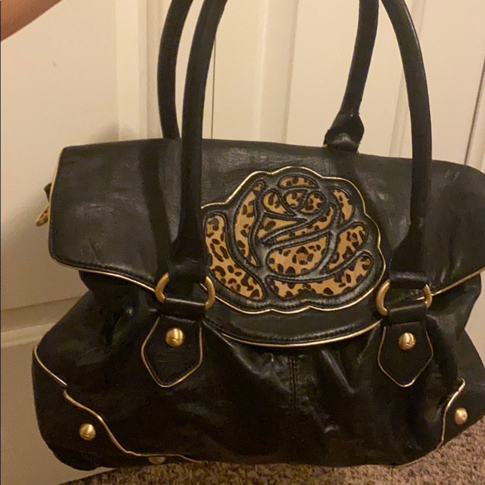 Leather Betsey Johnson purse with cheetah print.